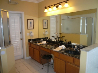 Master bath has a dual vanity with Hairdryer and a door that lets out onto the pool deck (with pool alarm).